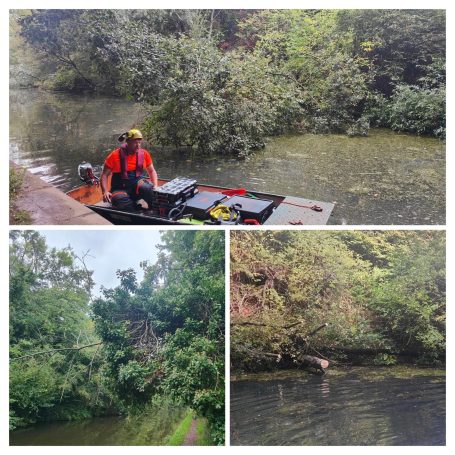 A person in a boat on a calm, green river surrounded by lush vegetation.